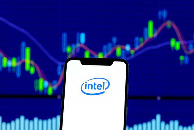 Mobiln telefon s npisem Intel na pozad s cenovm grafem akcie Intel